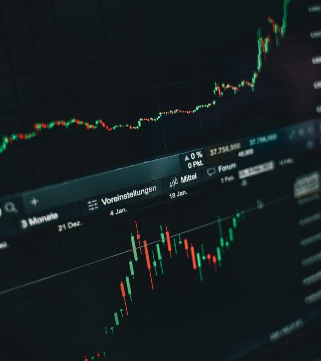Close-up of a digital market analysis display showing Bitcoin and cryptocurrency price trends.